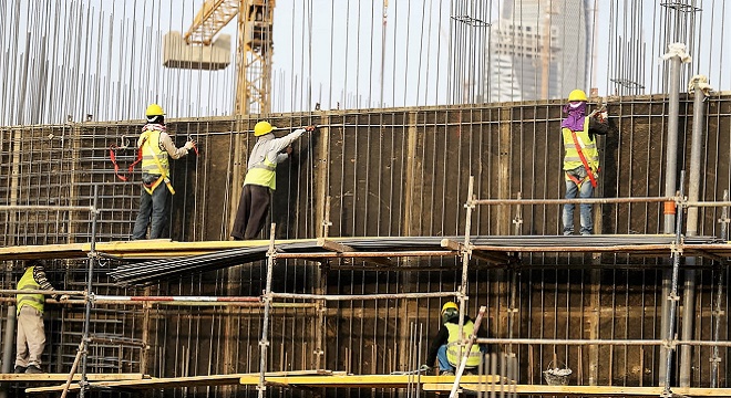 Indian labourers work at the construction site of a building in Riyadh