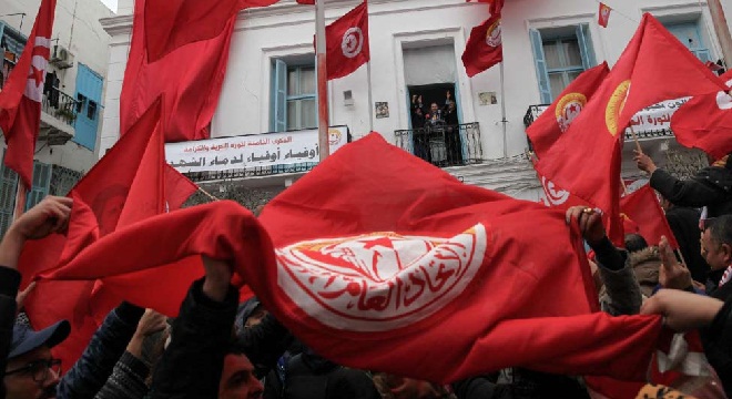 People gather during a nationwide strike against the government's refusal to raise wages in Tunis